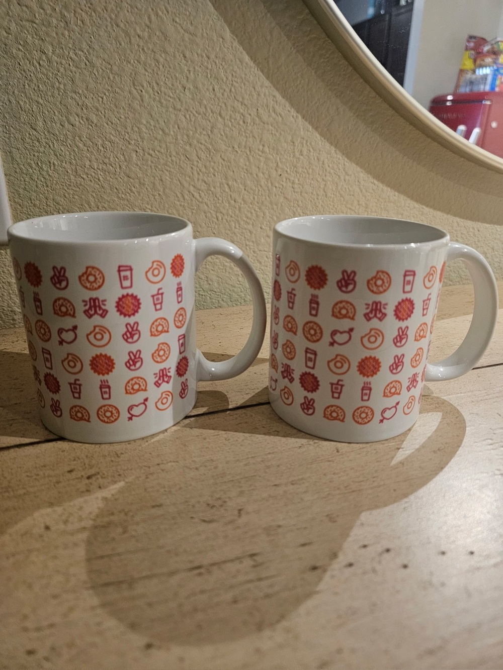 White Ceramic Mug Pair with Red and Orange Icon Pattern
